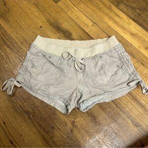Tan shorts with bows on the sides and adjustable waist